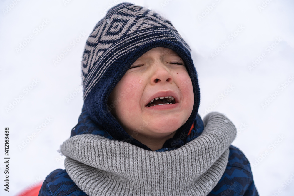 Little boy screams and cries. Emotions. Boy in winter clothes Little boy screams and cries. Emotions. Boy in winter clothes