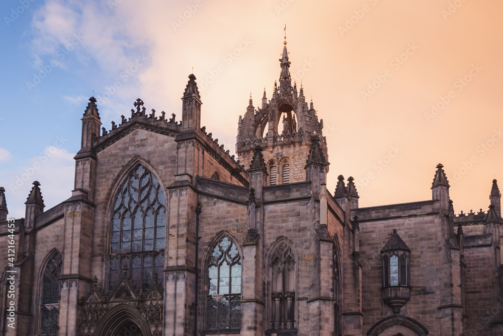 Closeup detail of gothic architecture of St, Giles' Cathedral against a dramatic sunset or sunrise sky along the Royal Mile in Edinburgh's Old Town.