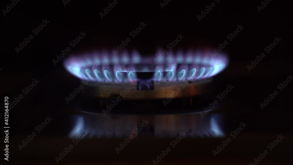 Closeup of the process of igniting a gas flame on a gas burner of a