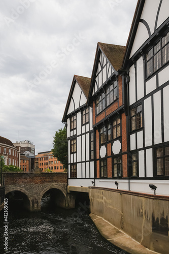 The historic 12th century Clattern Bridge over the Hogsmill River in the quaint old town of Kingston Upon Thames in southwest London, England. photo