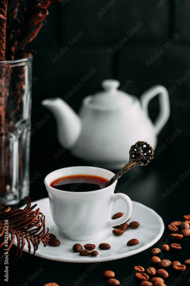 white coffee mug on black background with beans white coffee mug on black background with beans