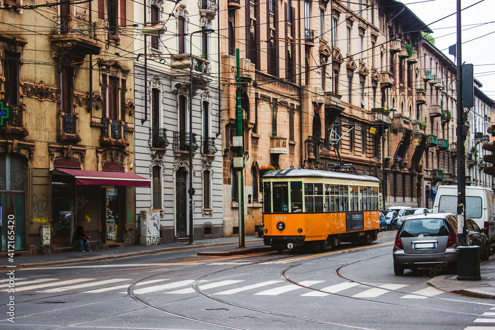 Vintage orange tram on the street of Milan near city center