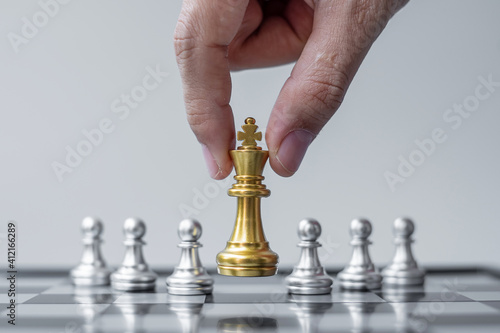 gold Chess King figure Stand out from the crowd on Chessboard background. Strategy, leadership, business, teamwork, different, Unique and Human resource management concept photo