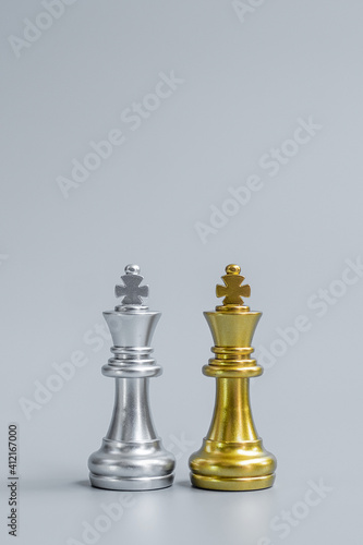 Gold and silver Chess King figure on Chessboard against opponent or enemy. Strategy, Conflict, management, business planning, tactic, politic, communication and leader concept