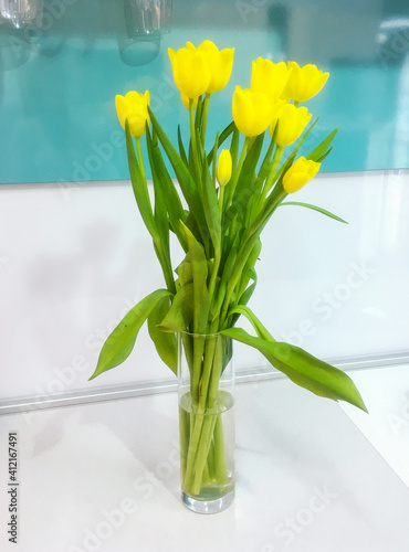 A bouquet of yellow tulips in a vase