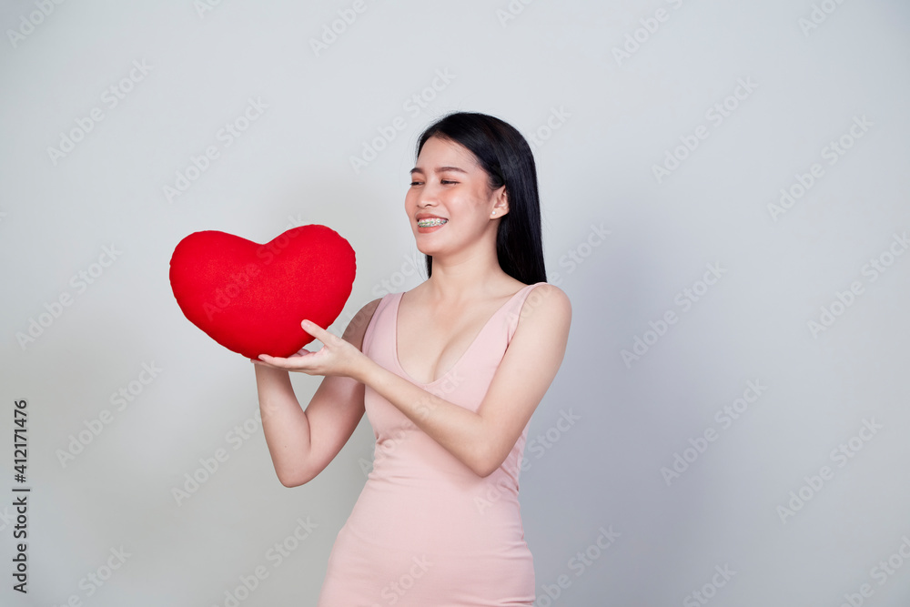 young Asian woman show heart shape pillow young Asian woman show heart shape pillow