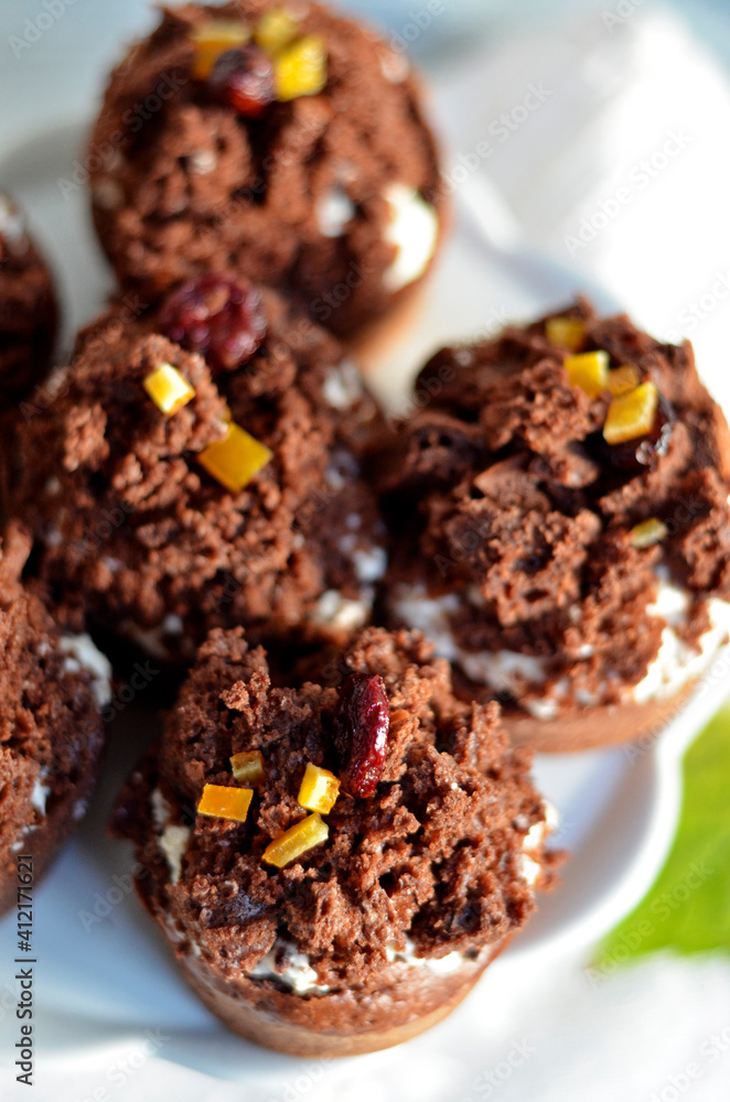 Chocolate muffins with cream on a white plate Chocolate muffins with cream on a white plate