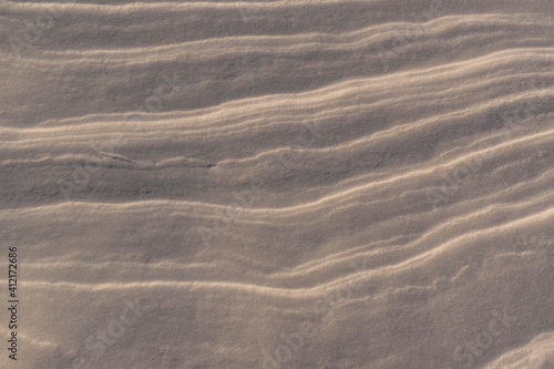Compressed layers of snow for the backdrop. Smooth contour lines of the layer. Shine.