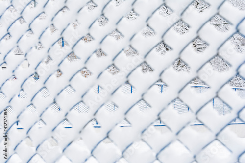 View of the snow-covered mesh netting. Background concept, nature.