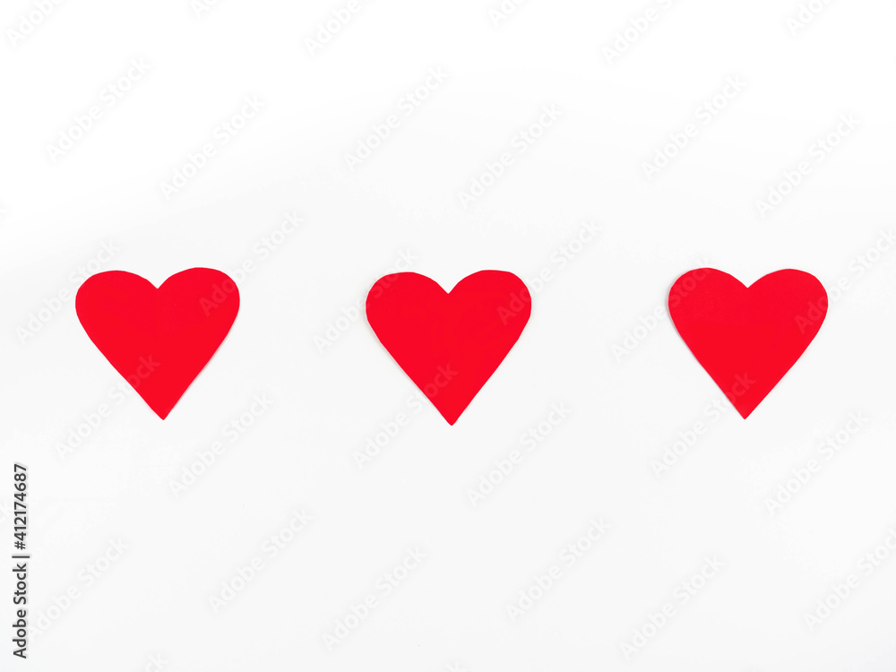Three red paper hearts On a white background