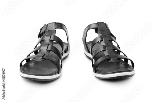 Black female sandals on white background isolated closeup front view, stylish woman sandal shoes with straps, pair of fashion leather summer sandals, two boots, casual walking footwear, urban footgear