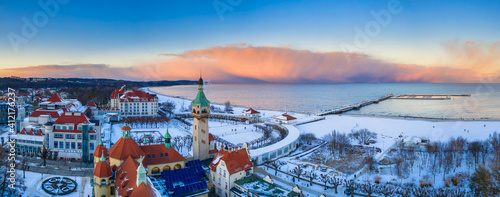 Beautiful sunset over the snowy beach and pier (Molo) in Sopot at winter. Poland photo