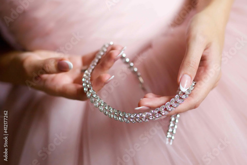 A luxury bracelet for the hand of a bride or a chic woman in close-up. Jewelry accessories.