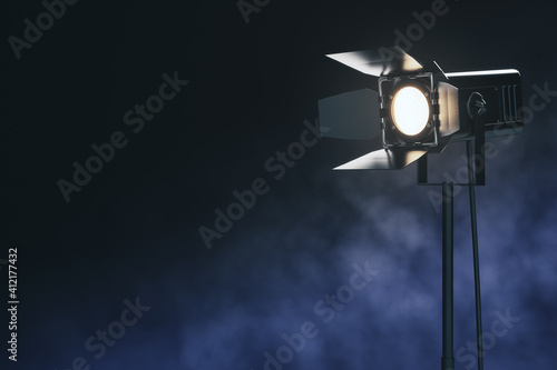 Illuminating black spotlight floor lamp among smoke at abstract dark background. Mockup. 3D rendering