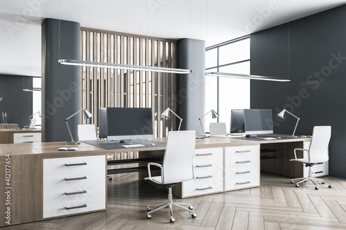 Modern office interior with dark wood tables, wooden floor, huge windows and massive partition. 3D rendering.