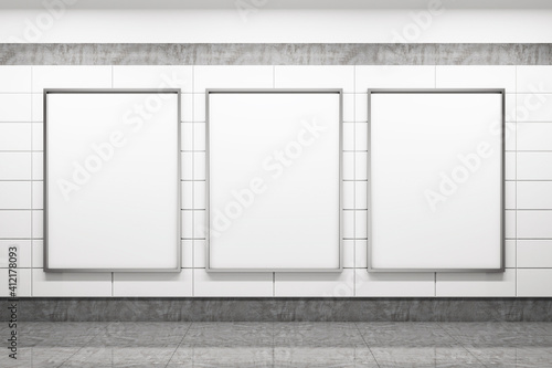 Subway station with three blank poster