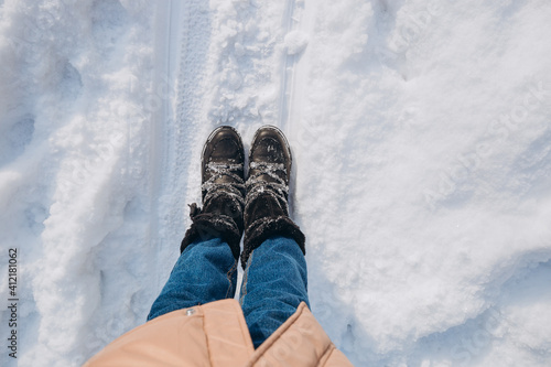 Black shoes standing on the snow Feet shoes walking in outdoor. Youth Selphie Modern hipster. Travel and discovery concept