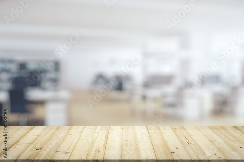 Empty wooden tabletop with modern furnished office on background, mock up © Pixels Hunter