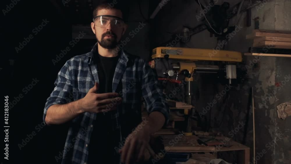 Portrait of man in protective eye wear at wood workshop Portrait of man in protective eye wear at wood workshop