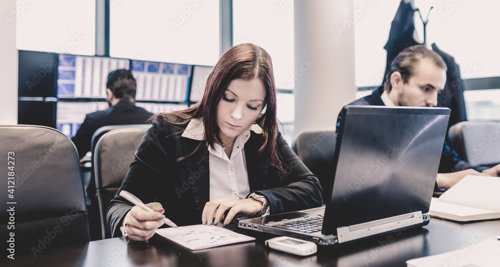 Businesspeople working on laptops in modern office. Businesspeople working on laptops in modern office.