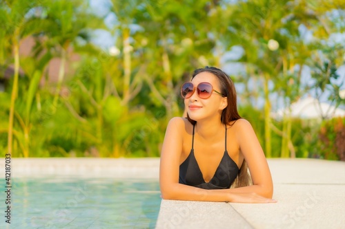 Portrait beautiful young asian woman relax smile enjoy leisure around swimming pool © siraphol