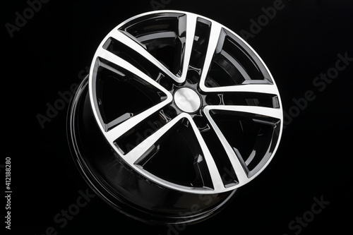 new shiny alloy wheel, color black with silver front. Dark background © Vladimir Razgulyaev