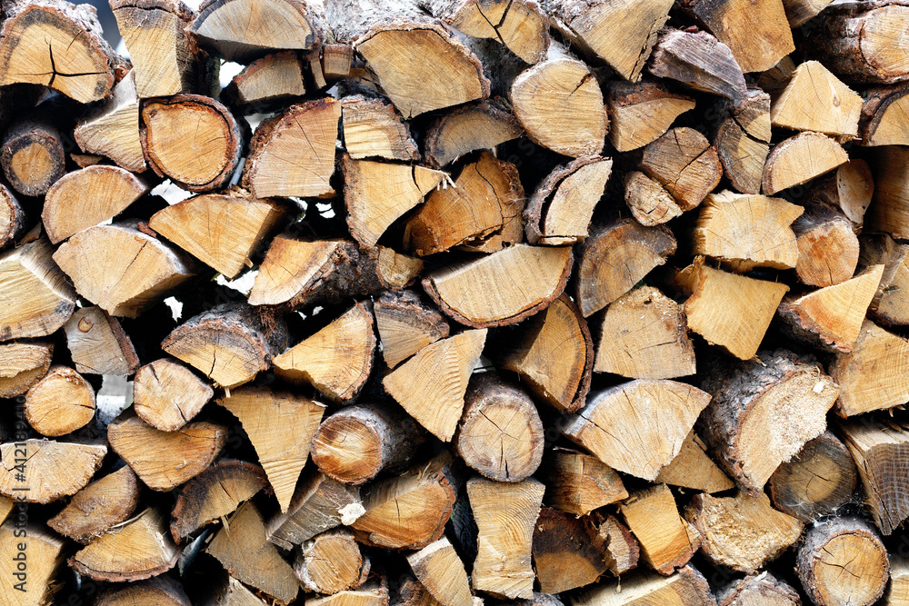 Roughly chopped wood, neatly stacked on top of each other. Roughly chopped wood, neatly stacked on top of each other.