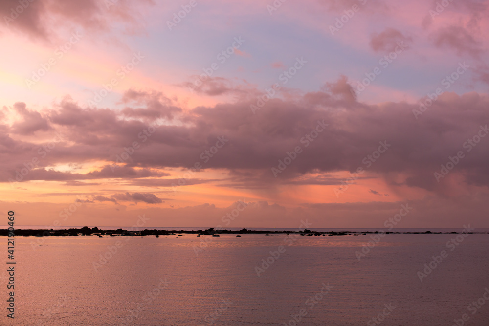 Aerial panoramic view of sunset over ocean.