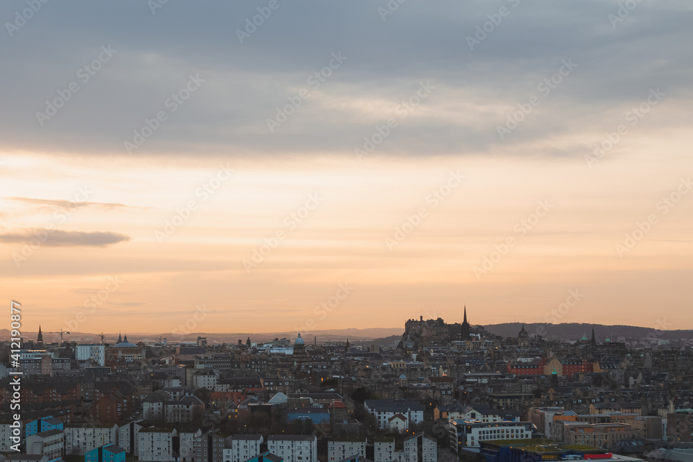 A view of Edinburgh's old town cityscape skyline at sunset or sunrise from Salisbury Crags.