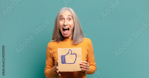 gray hair pretty woman holding a social media like banner photo