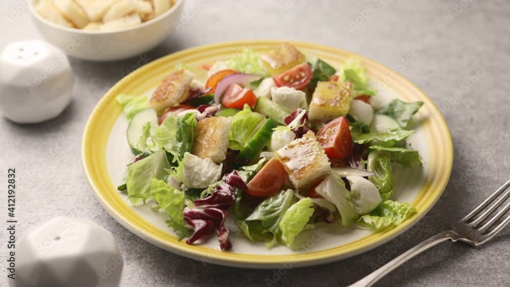 Salad of fresh vegetables and crackers is poured with olive oil Salad of fresh vegetables and crackers is poured with olive oil