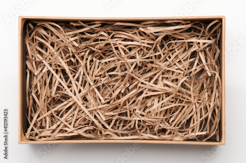 Open brown box with shredded paper photo