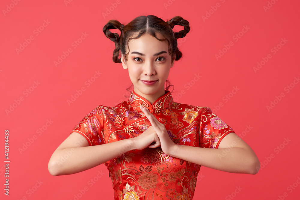 Asian chinese woman in traditional dress on red background. Chinese new year festival. Stock Photo Adobe Stock