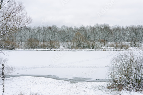 The frozen river is covered with ice. winter background