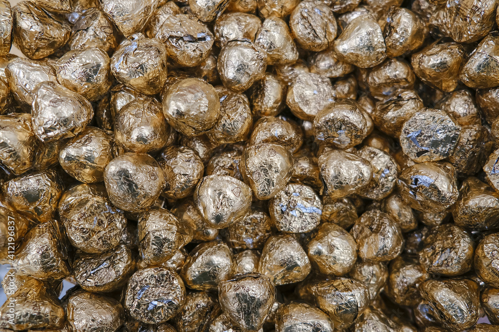 Chocolate candies in a gold wrapper Chocolate candies in a gold wrapper