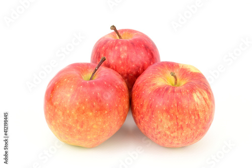 Three red ripe apples isolated on white background