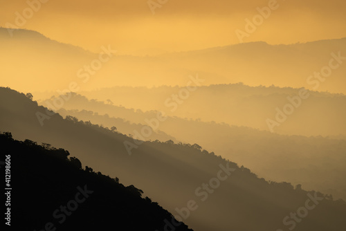 Fototapeta Naklejka Na Ścianę i Meble -  nature landscape view, mountain layers sunset in gold yellow color, concept of freedom relax using for spa and natural healing therapy, sky sun light with hill scenic, travel outdoors