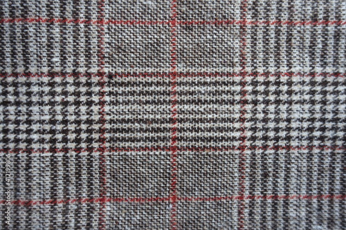 Top view of gray and red Glen check fabric