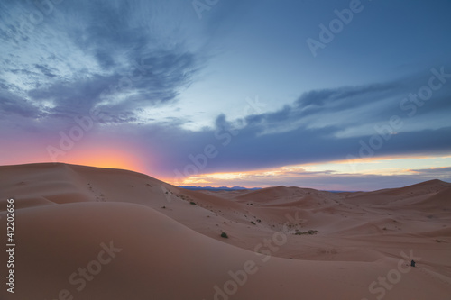 A sunrise or sunset landscape view of the desert sand dunes of Erg Chebbi near the village of Merzouga  Morocco.