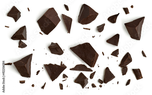 Broken, cracked or crushed dark chocolate parts from top view isolated on white background	