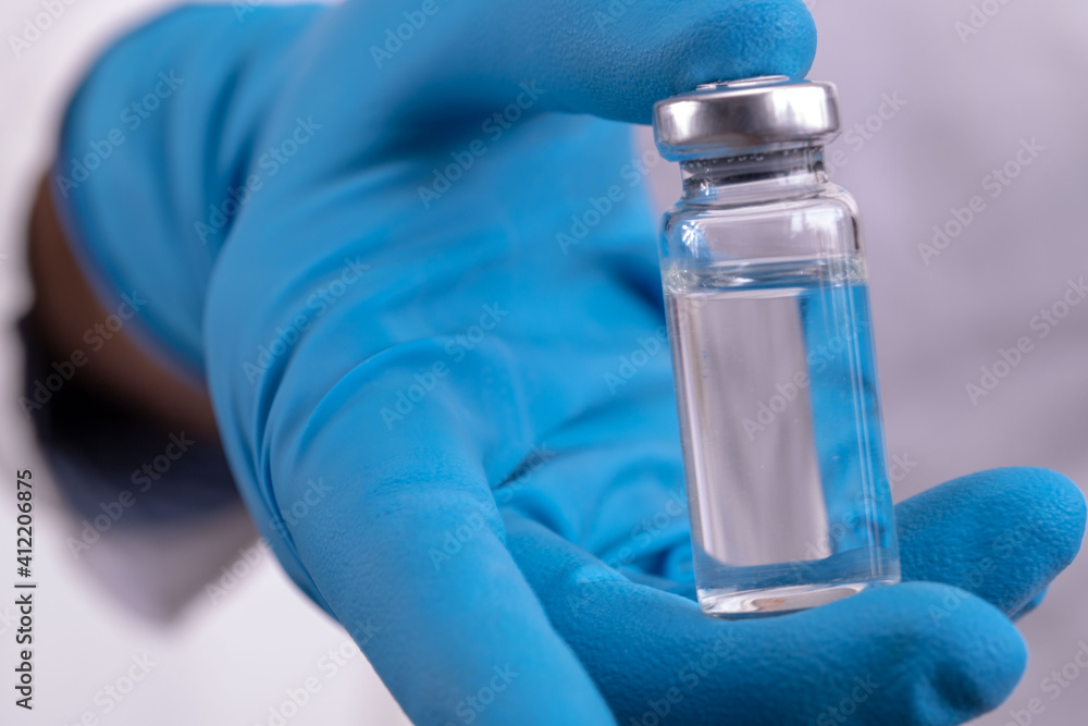 Development and creation of a coronavirus vaccine COVID-19 .Coronavirus Vaccine concept in hand of doctor blue vaccine jar. Vaccine Concept of fight against coronavirus. Development and creation of a coronavirus vaccine COVID-19 .Coronavirus Vaccine concept in hand of doctor blue vaccine jar. Vaccine Concept of fight against coronavirus.