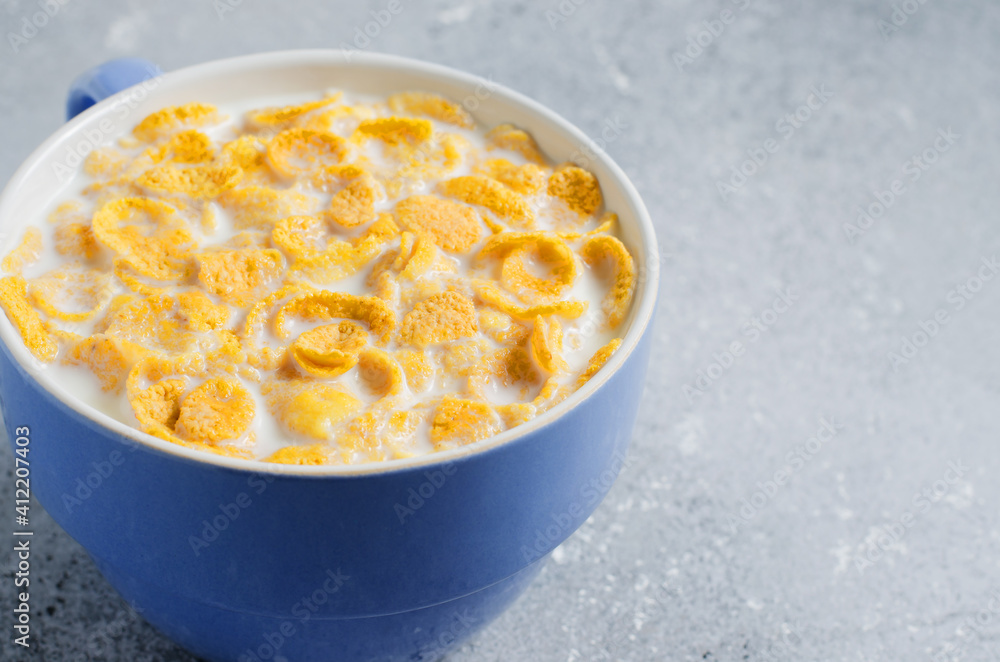 Corn flakes in milk. Blue Cup. Healthy and nutritious Breakfast. Copy space. Corn flakes in milk. Blue Cup. Healthy and nutritious Breakfast. Copy space.