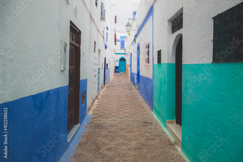 An old town alley and colourful backstreet in Asilah, a fortified seaside town on the northwest tip of Morocco's Atlantic coast. © Stephen
