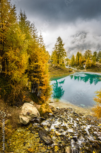 autumn mood over alpine lake in Valais