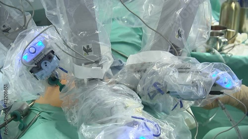 Surgeon operating with medical robotic surgery machine.
