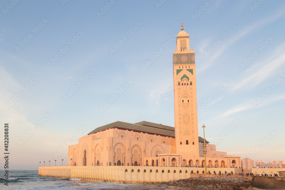 The grand and iconic Hassan II Mosque at sunset on a beautiful evening in Casablanca, Morocco.