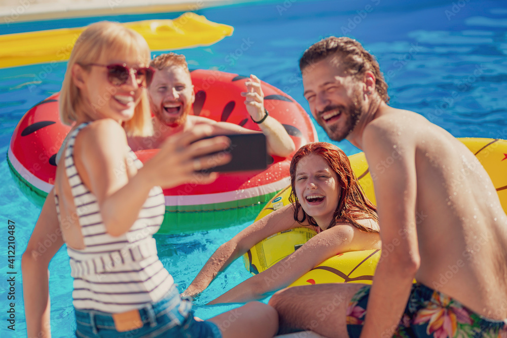 Friends taking a selfie at the swimming pool