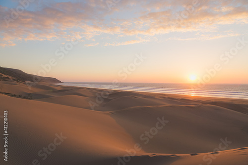 Sunset at the sandy dunes at the beach outside the seaside fishing village of Tafedna in Essaouira province, Morocco.