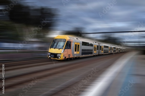 Sydney Train heading through Summerhill Station with background motion blur NSW Australia