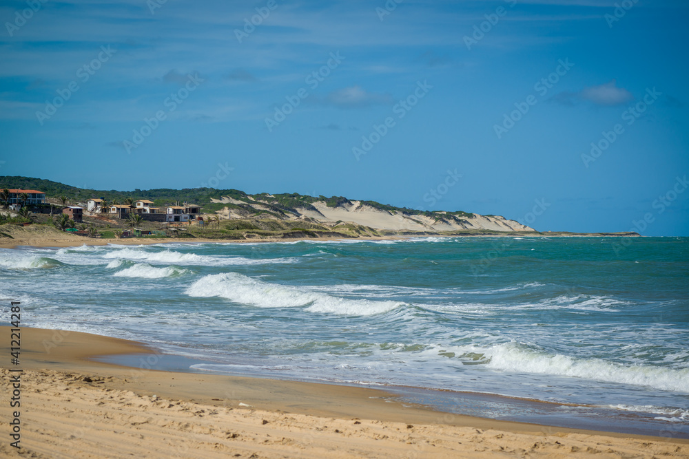 Sea with waves and dunes at Praia do Sagi, Baia Formosa, near Natal, Rio Grande do Norte State, Brazil on January 26, 2021. Sea with waves and dunes at Praia do Sagi, Baia Formosa, near Natal, Rio Grande do Norte State, Brazil on January 26, 2021.